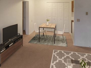 Rockford apartment for rent - A living room with a television, a table with chairs, and a rug.