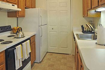 Well equipped kitchen with white appliances