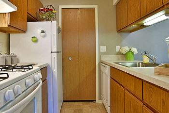 Galley style kitchen with white appliances