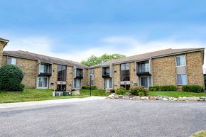 Greendale apartment for rent - Apartment complex with a grey road in front.