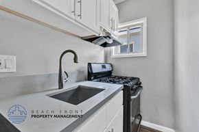 Long Beach apartment for rent - a kitchen with a sink and a stove and a window