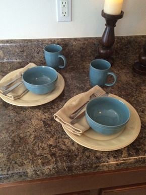 Fayetteville triplex for rent - a counter top with plates and cups on it