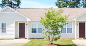 Fayetteville triplex for rent - a white house with a tree in front of it