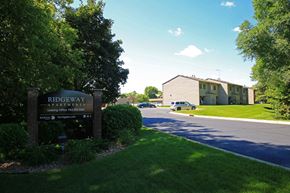Monticello townhouse for rent - a sign for the ridgeway apartments in front of a road and a building