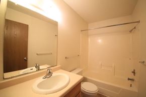 Monticello townhouse for rent - a bathroom with a sink and a tub and a mirror