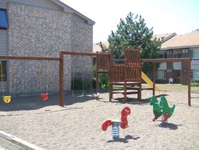 Monticello townhouse for rent - two dinosaurs playing in a playground with a swing