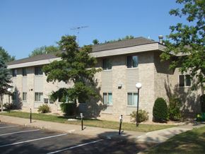 Mora apartment for rent - an apartment building with a parking lot and trees