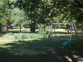 Mora apartment for rent - a swing set in the shade of a tree