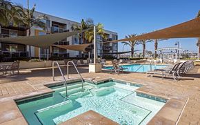 Marina Del Rey apartment for rent - a swimming pool with chairs and umbrellas in front of a hotel