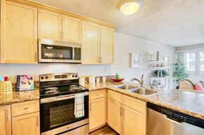 Marina Del Rey apartment for rent - a kitchen with wooden cabinets and appliances and granite counter tops