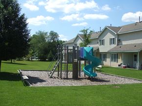 St. Louis Park townhouse for rent - a playground with a slide in front of a house