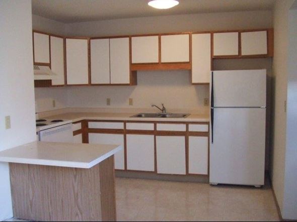 St. Louis Park townhouse for rent - an empty kitchen with white cabinets and a white refrigerator