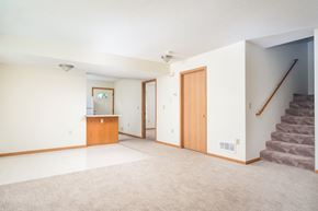 Eden Prairie townhouse for rent - A room with a staircase on the right side.