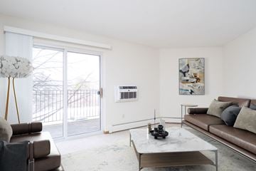 Plymouth apartment for rent - A living room with a couch, coffee table, and a painting on the wall.