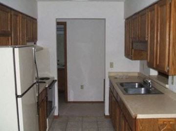 Young America townhouse for rent - a kitchen with a sink and a refrigerator