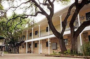 Austin apartment for rent - a large building with a tree in front of it