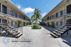 Anaheim apartment for rent - A sunny day at the beachfront property with palm trees and balconies.