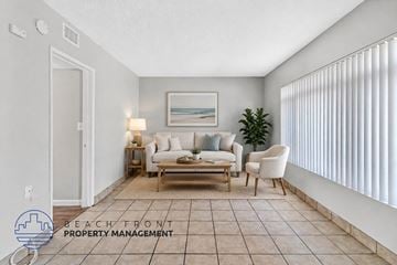 Anaheim apartment for rent - A living room with a couch, chair, and a painting on the wall.