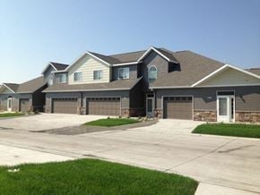 Grand Forks townhouse for rent - a large house with a driveway and garage doors