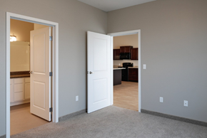 Grand Forks townhouse for rent - a bedroom with a door open to a kitchen and a living room