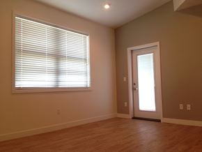 Grand Forks townhouse for rent - an empty living room with a large window and a door