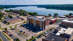 Menomonie apartment for rent - an aerial view of a building with a lake in the background