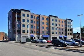 Menomonie apartment for rent - a large building with cars parked in a parking lot