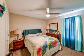 Columbus apartment for rent - a bedroom with a bed and a ceiling fan
