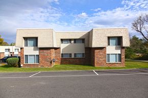 Scottsville apartment for rent - an image of a brick apartment building in a parking lot