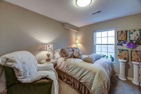 Willowick apartment for rent - a bedroom with a bed and a chair and a window