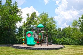 Harrodsburg apartment for rent - a playground with a swing set and a slide in a park