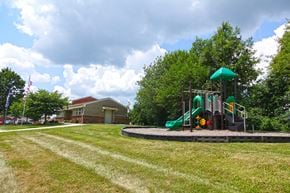 Harrodsburg apartment for rent - a playground in a yard with a house in the background