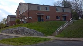 Tompkinsville apartment for rent - a house on a hill with stairs in front of it