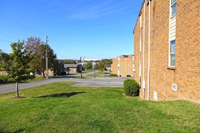 Nashville apartment for rent - the side of a brick building with a green lawn