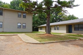 Gates apartment for rent - the exterior of a house with a tree in the yard