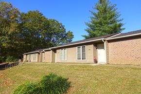 Huntingdon apartment for rent - a brick house with a yard and a tree