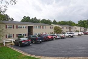 Pocahontas apartment for rent - a parking lot full of cars in front of an apartment building