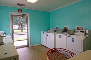 Sikeston apartment for rent - a laundry room with refrigerators and a door to an exit