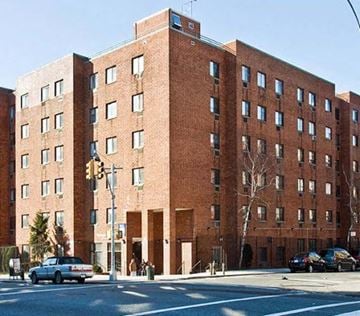 New York apartment for rent - a large brick building on the corner of a street