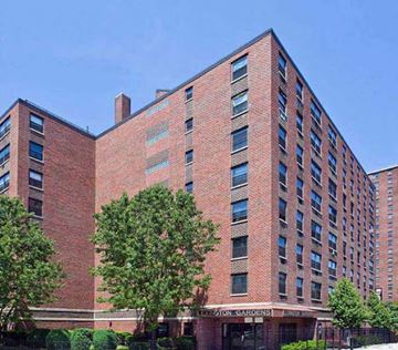 New York apartment for rent - a large brick building with trees in front of it