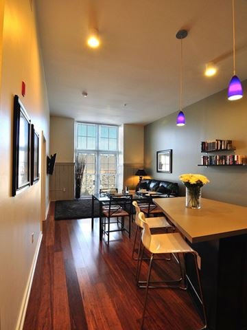 Baltimore apartment for rent - A living room with a long wooden table and chairs.