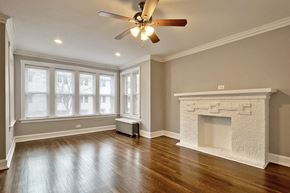 Oak Park apartment for rent - A room with a fireplace and a ceiling fan.
