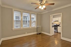 Oak Park apartment for rent - A room with a ceiling fan and a window with blinds.