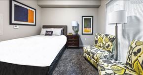 Bellevue apartment for rent - a bedroom with a bed and a chair and a window