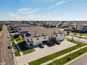 Fargo townhouse for rent - an aerial view of a row of houses in a parking lot