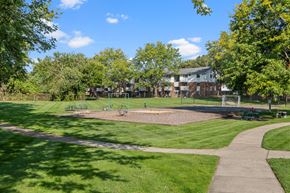Wyoming apartment for rent - A park with a playground and a building in the background.