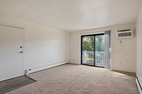 Wyoming apartment for rent - A room with a sliding glass door leading to a balcony.
