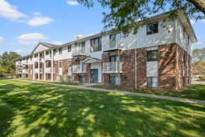 Wyoming apartment for rent - A large apartment complex with multiple balconies and doors.