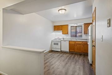 Wyoming apartment for rent - A kitchen with white appliances and wooden cabinets.
