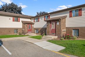 Wyoming apartment for rent - A row of houses with red doors and windows.